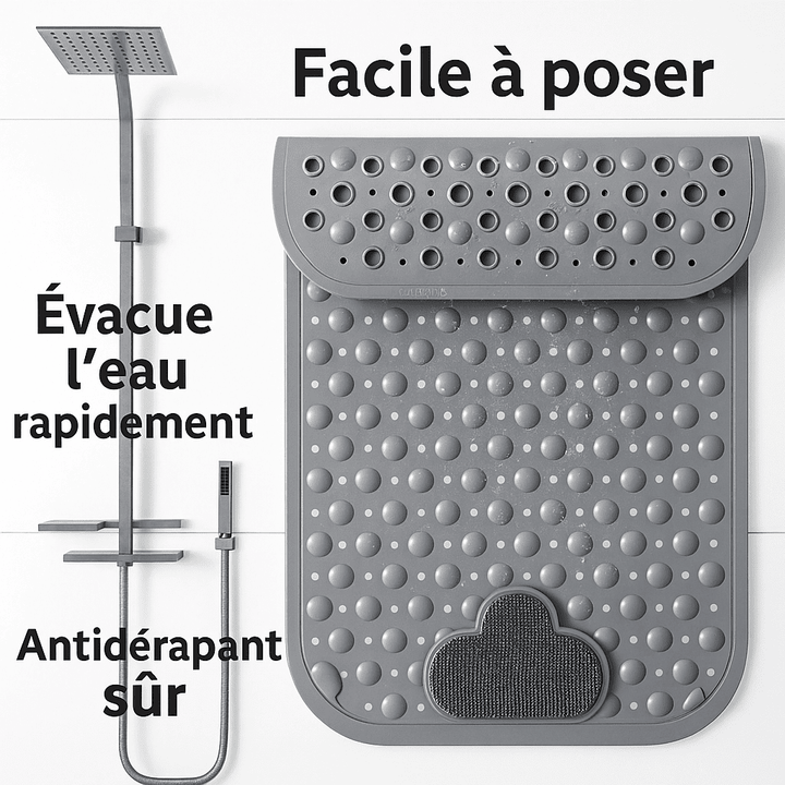 Vue suspendue d’un tapis de bain antidérapant gris à picots, montrant sa pose facile et ses perforations pour une évacuation rapide de l’eau.