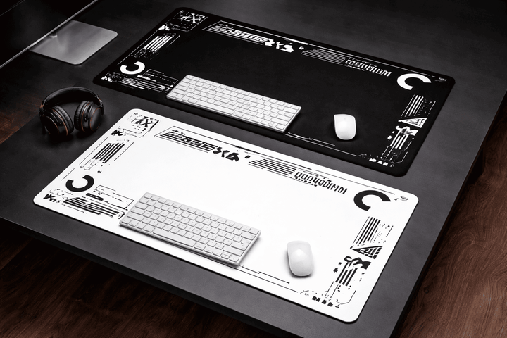 Deux tapis de souris 900x400 noir et blanc installés sur un bureau avec clavier et souris